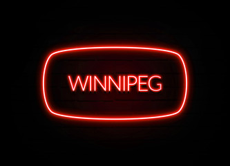 Winnipeg neon sign on brick wall background.