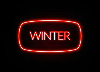 Winter neon sign on brick wall background.