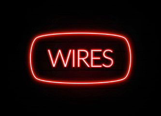 Wires neon sign on brick wall background.