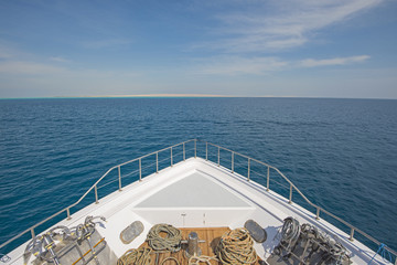 View over the bow over a large luxury motor yacht