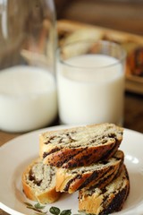 Fresh baked poppy seed roll and milk on the table  