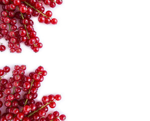 Ripe red currants on white background. Berries at border of image with copy space for text. Background berries. Top view. Various fresh summer berries on white