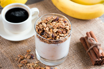 Cup of breakfast healthy muesli with banana and yogurt