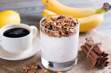 Cup of breakfast healthy muesli with banana and yogurt