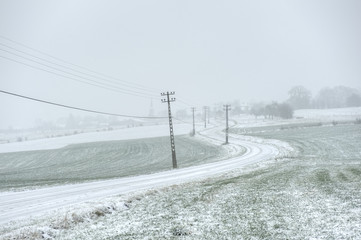 Village of Froidfointaine in a winterisch setting with icy winding road