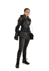 full length portrait of female  soldier wearing black  tactical armour, isolated on white studio background.