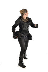 Fototapeta premium full length portrait of female soldier wearing black tactical armour, isolated on white studio background.
