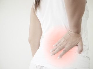 Close up woman having pain in injured back. Health care and back pain concept.