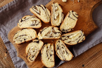 Fresh baked poppy seed roll on the table   