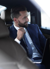 Close-up of a successful businessman sitting in a comfortable car