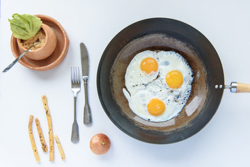 Simple morning breakfast, eggs, leek and breadsticks