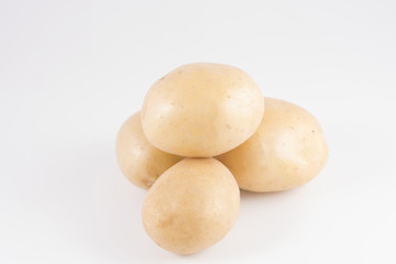 Fototapeta na wymiar Some potatoes on a white surface