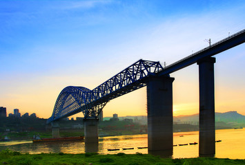 Spectacular railway bridge across the Yangtze River, at sunset in summer in Chongqing, China