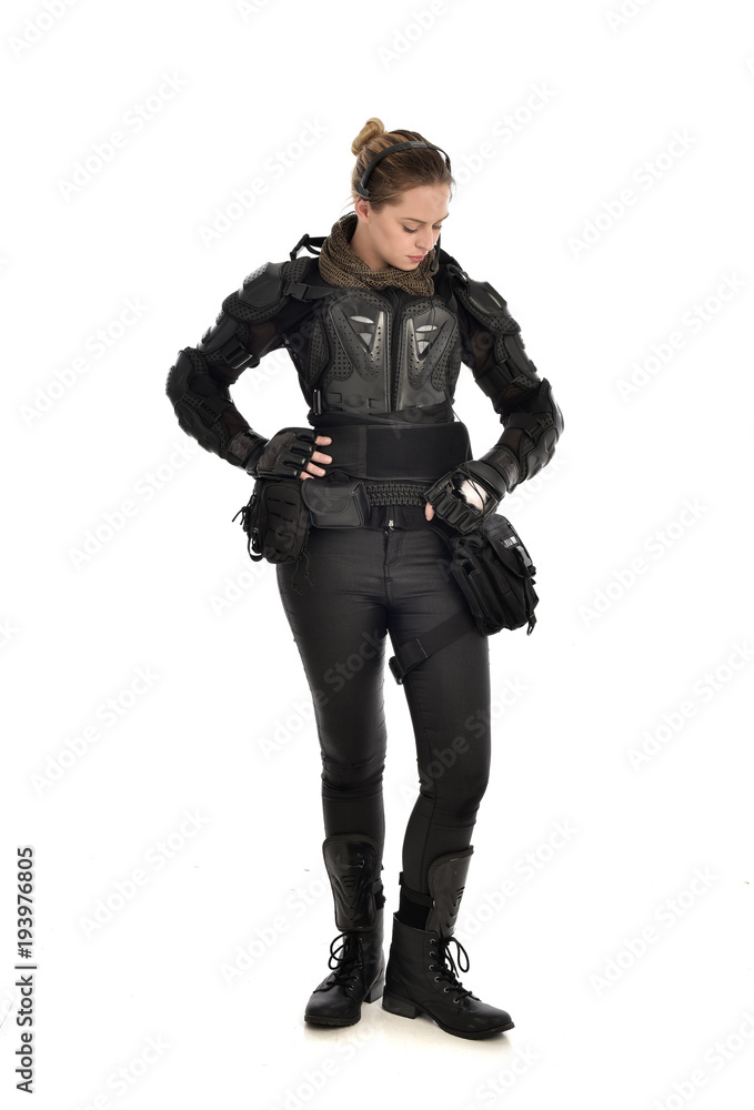 Canvas Prints full length portrait of female  soldier wearing black  tactical armour, isolated on white studio background.