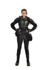full length portrait of female  soldier wearing black  tactical armour, isolated on white studio background.