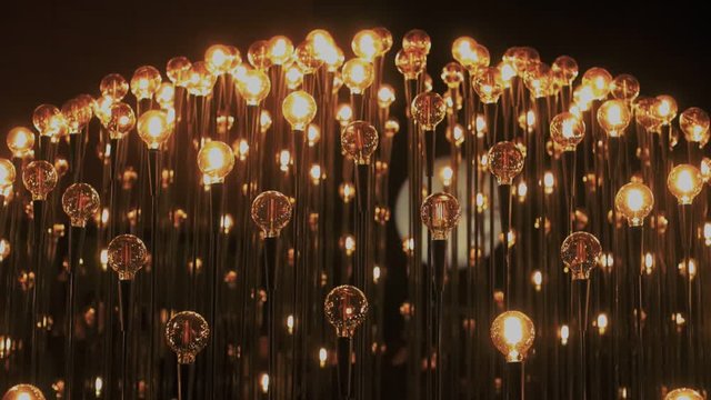 Inspiring and futuristic concept of performance using light bulbs as symbol of ideas and creativity of science and technology. Vintage tungsteen bulbs light up darkness