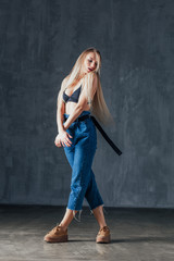 Young beautiful female dancer is posing in the studio