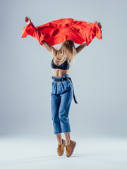 Young beautiful female dancer is posing in the studio