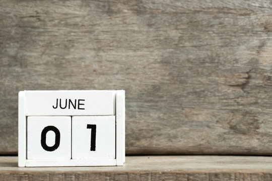 White block calendar present date 1 and month June on wood background