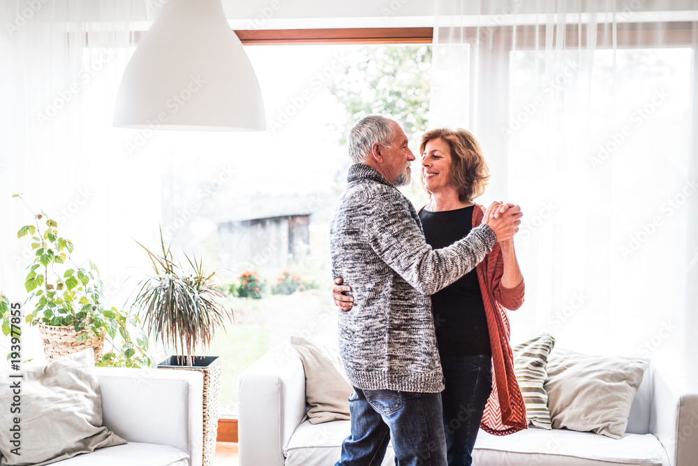 Canvas Prints Senior couple relaxing at home, dancing.