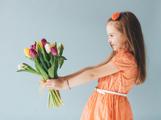 Young child holding a bunch of fresh flowers
