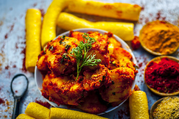 Indian appetizer dish i.e.Teekha Laal Batata or Spicy potato with  all its ingredients and spices...