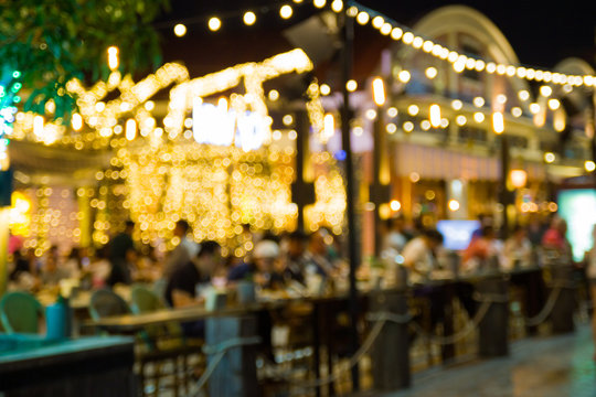 abstract blur image of night festival in a restaurant and The atmosphere is happy and relaxing with bokeh for background

