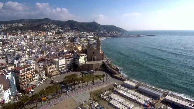 Flying over the church of Santa Tecla in Sitges. Aerial view.
