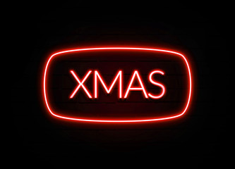 Xmas neon sign on brick wall background.