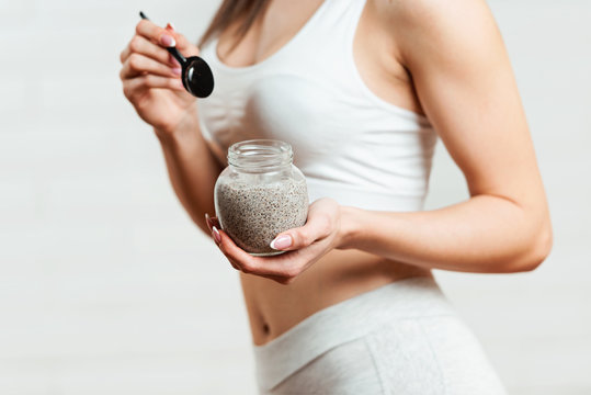 Fit, Attractive Woman Holding A Glass Jar Of Chia Pudding 