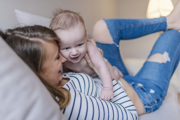 cute mother and child boy play together indoors at home