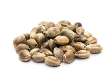Close up of a small pile of hemp seeds on white background
