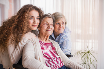 A teenage girl with mother and grandmother at home.