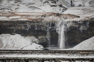 Fototapeta premium Scenic view of famous Seljalandsfoss waterfall in winter Iceland.