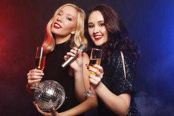 lifestyle and people concept: two beautiful   women with wine gl