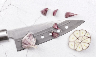 Macro closeup of a freshly cut garlic bulb with a knife
