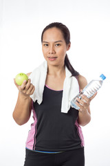 Naklejka premium portrait fitnees woman holding a bottle of water with apples isolated on white background