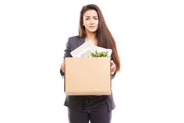 Portrait of young businesswoman holding box with personal belongings
