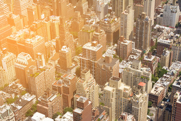 Overhead view of buildings in New York City with sunlight shining