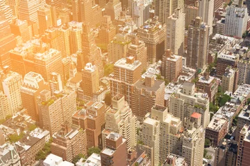 Fotobehang Overhead view of buildings in New York City with sunlight shining © deberarr