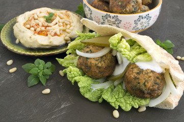 Arabic food. Hummus and falafel on a gray background.