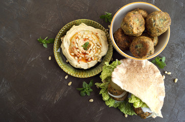 Arabic food. Hummus and falafel on a gray background.