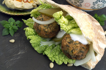 Arabic food. Hummus and falafel on a gray background.