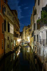 Fototapeta na wymiar Long night exposure of an old Venetian canal in vertical view