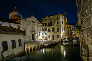 Fototapeta na wymiar Long night exposure of an old Venetian canal in horizontal view