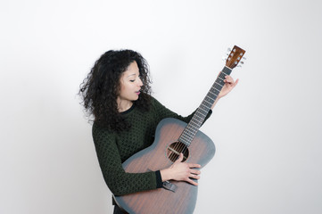 Fototapeta premium Young latin woman with a guitar