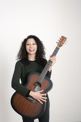 Fototapeta premium Young latin woman with a guitar