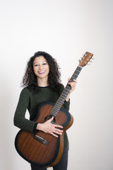 Fototapeta premium Young latin woman with a guitar