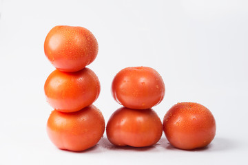 Tomatoes on a white background in the form of a staircase