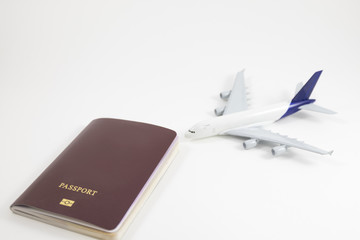 white background passport and model plane placed on white floor with copy space. image for business, document, isolated, travel, person, identification, holiday, tourist concept